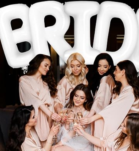 Bride-to-be posing under white BRIDE balloons