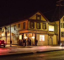 Checkered dance floor and vintage murals inside The Commodore