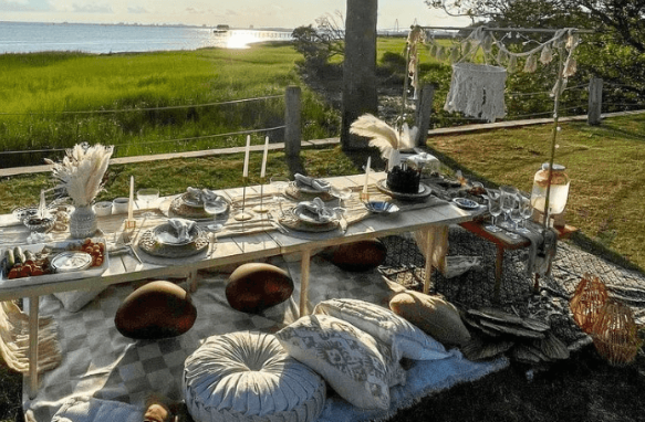 Luxury bachelorette picnic setup with low table, cushions and florals in Charleston