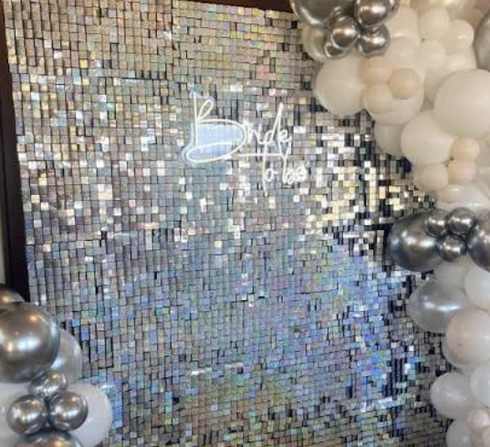 Balloon garland and photo backdrop in a styled rental house