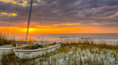 Small boat anchored at a quiet beach near Folly Beach