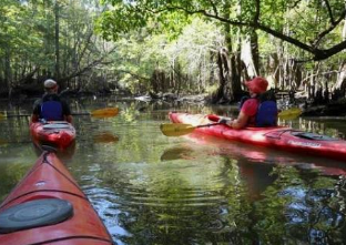 Bachelorette group kayaking past shrimp boats on Shem Creek