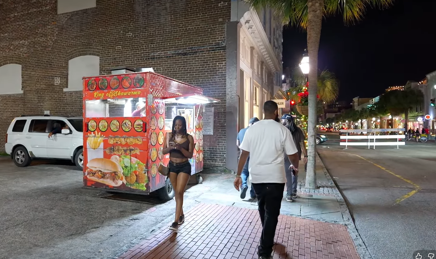 A slice of pizza on King Street at night